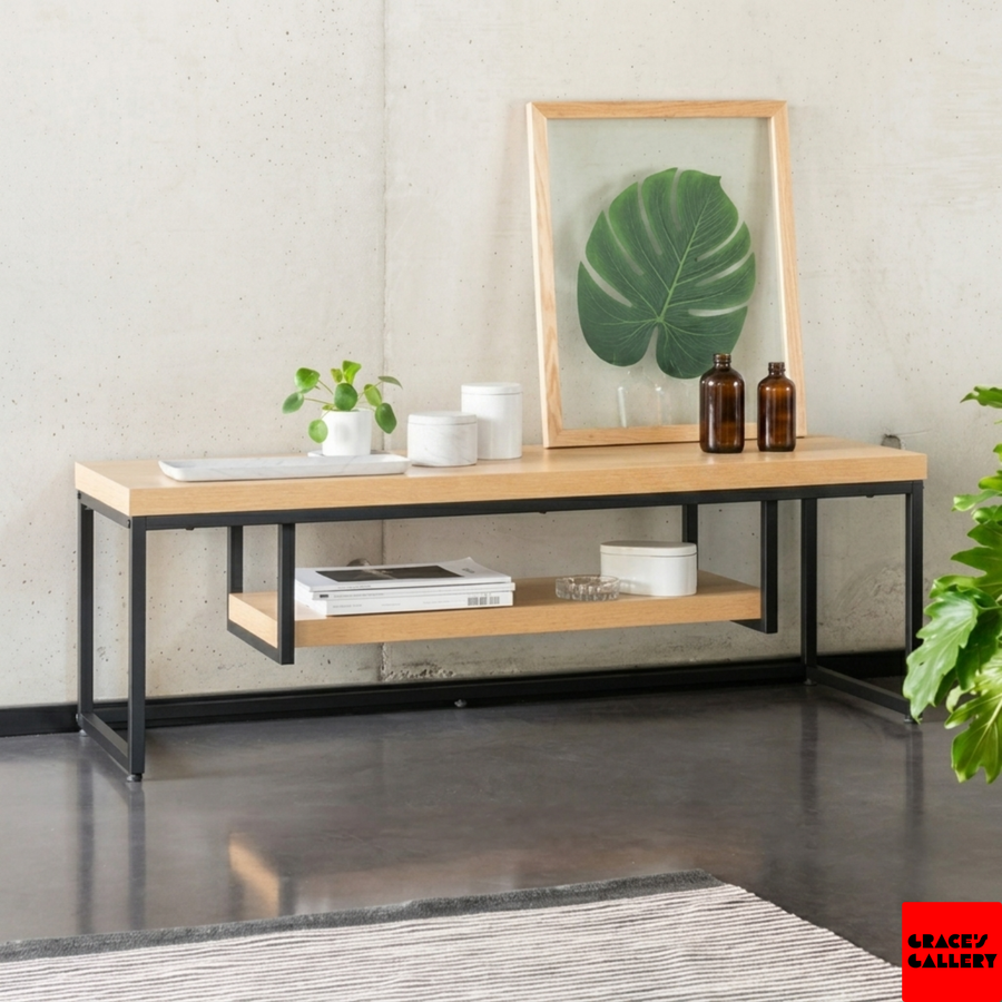 Pine and steel media console styled with a plant, vases and framed leaf print