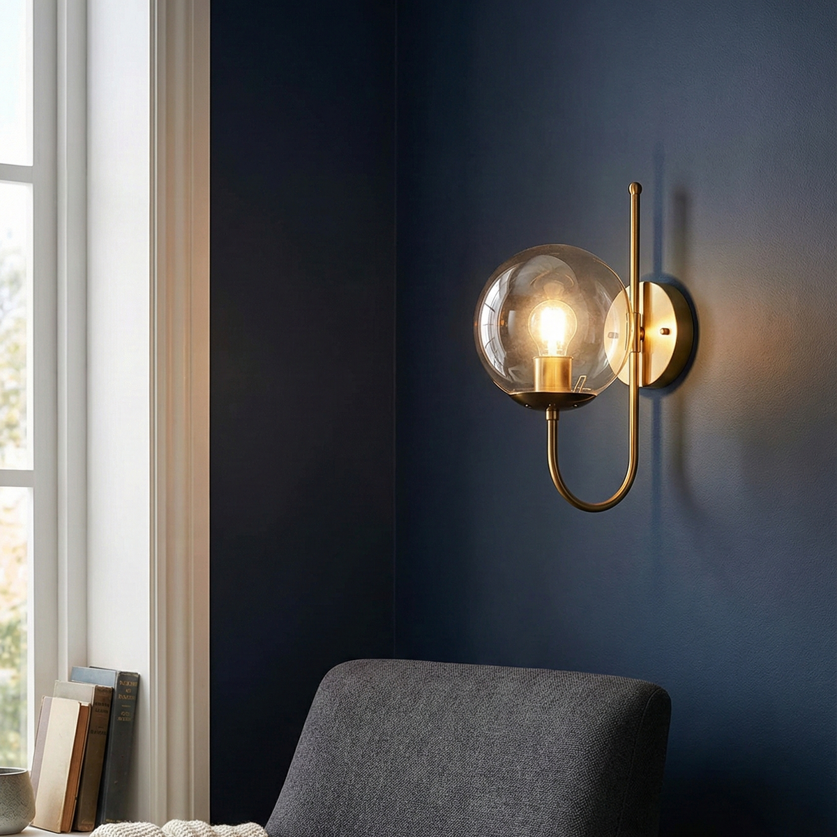 Modern wall sconce with glass shade in a cozy living room setting.