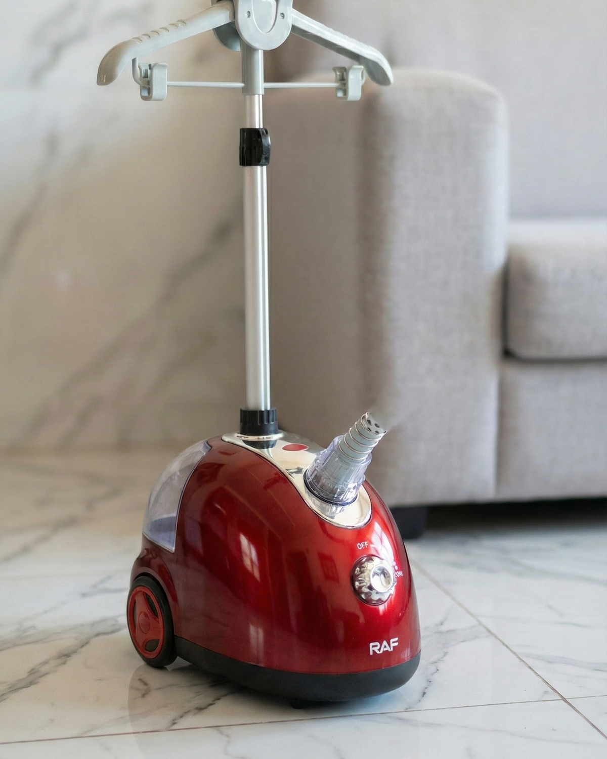 Red vacuum cleaner with a cat sitting on top in a living room setting