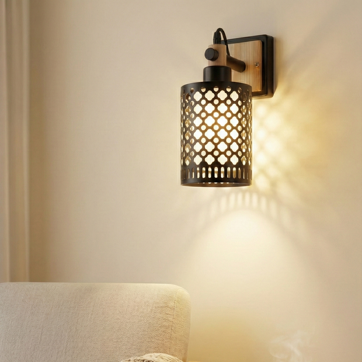 Decorative wall sconce casting a warm glow in a cozy room with a chair and small table.