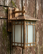 Wooden outdoor wall light fixture on a wooden background