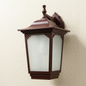 Brown outdoor wall light fixture on a beige wall