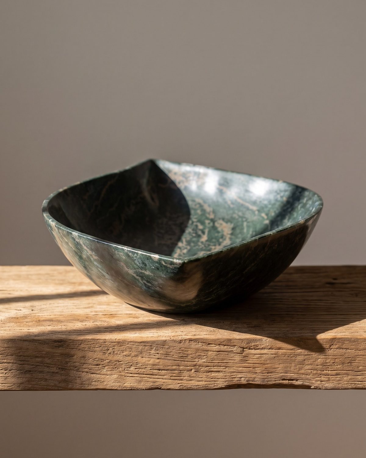 Forest Fold serpentine stone serving bowl on a sunlit wooden shelf