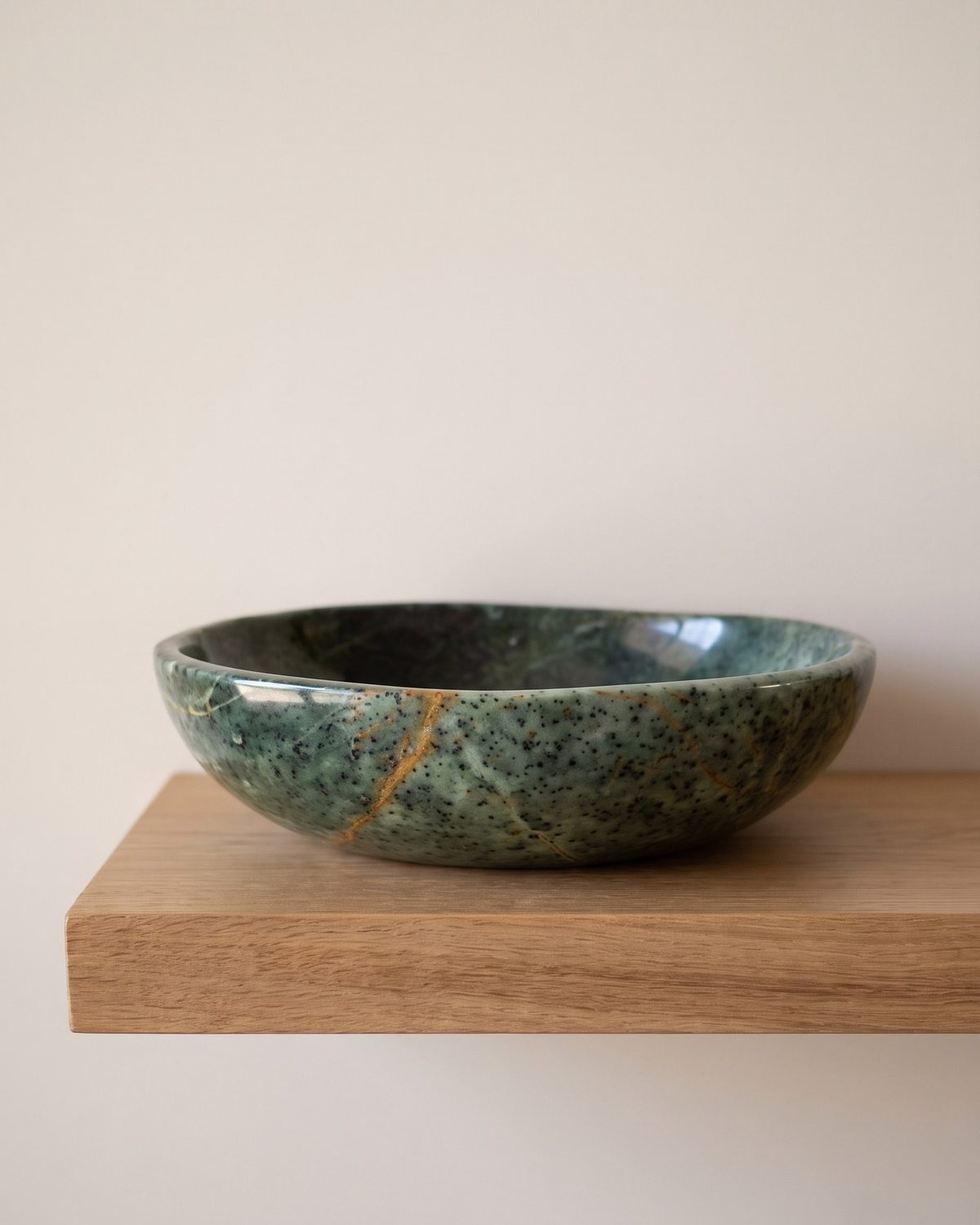 Jade Ember serpentine stone serving bowl on a sunlit wooden shelf