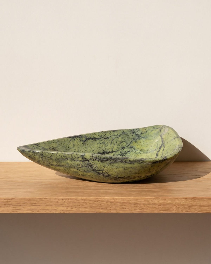 Lime Vein serpentine stone serving bowl on a sunlit wooden shelf