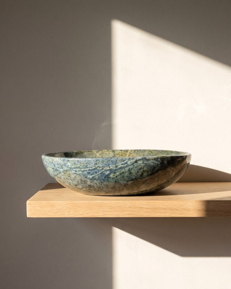 Ocean Mist serpentine stone serving bowl on a sunlit wooden shelf